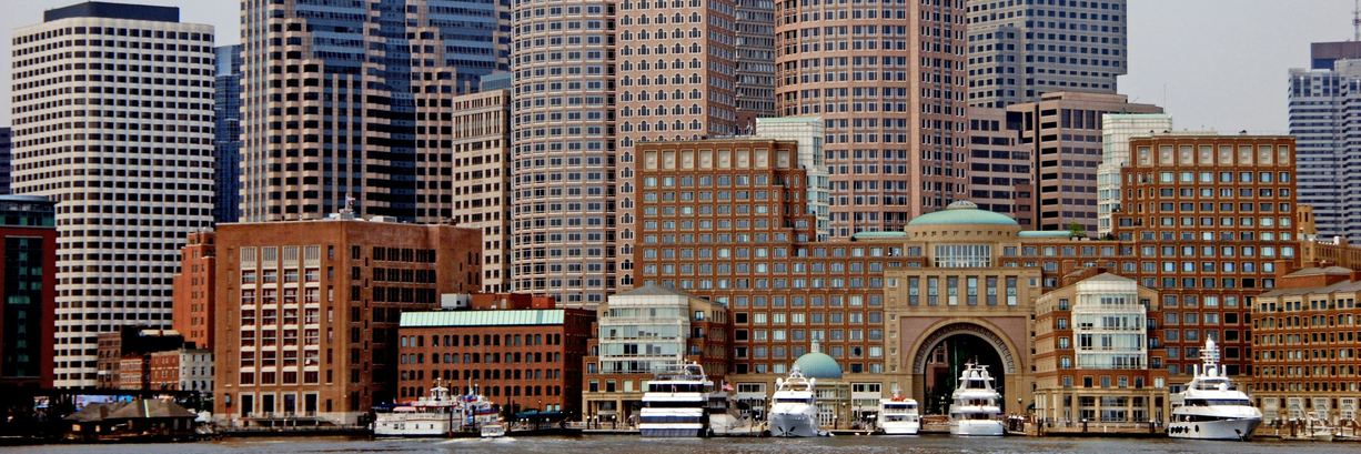 Boston's downtown towers rising behind the brick waterfront of Rowes Wharf
