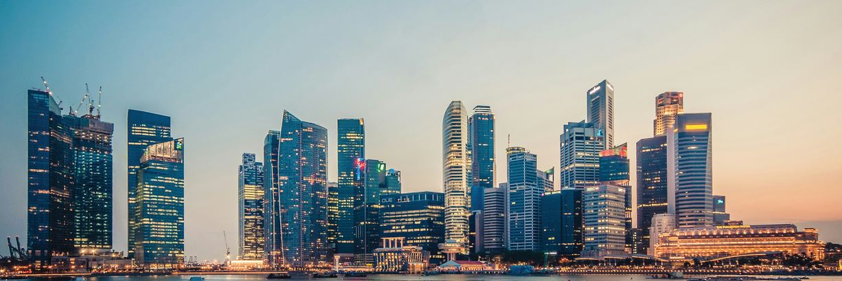 Singapore's central business district at dusk, seen across Marina Bay